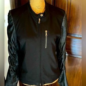 Black semi leather jacket with zippers.